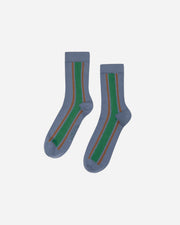 Pair of blue socks with green and brown stripes on a white background