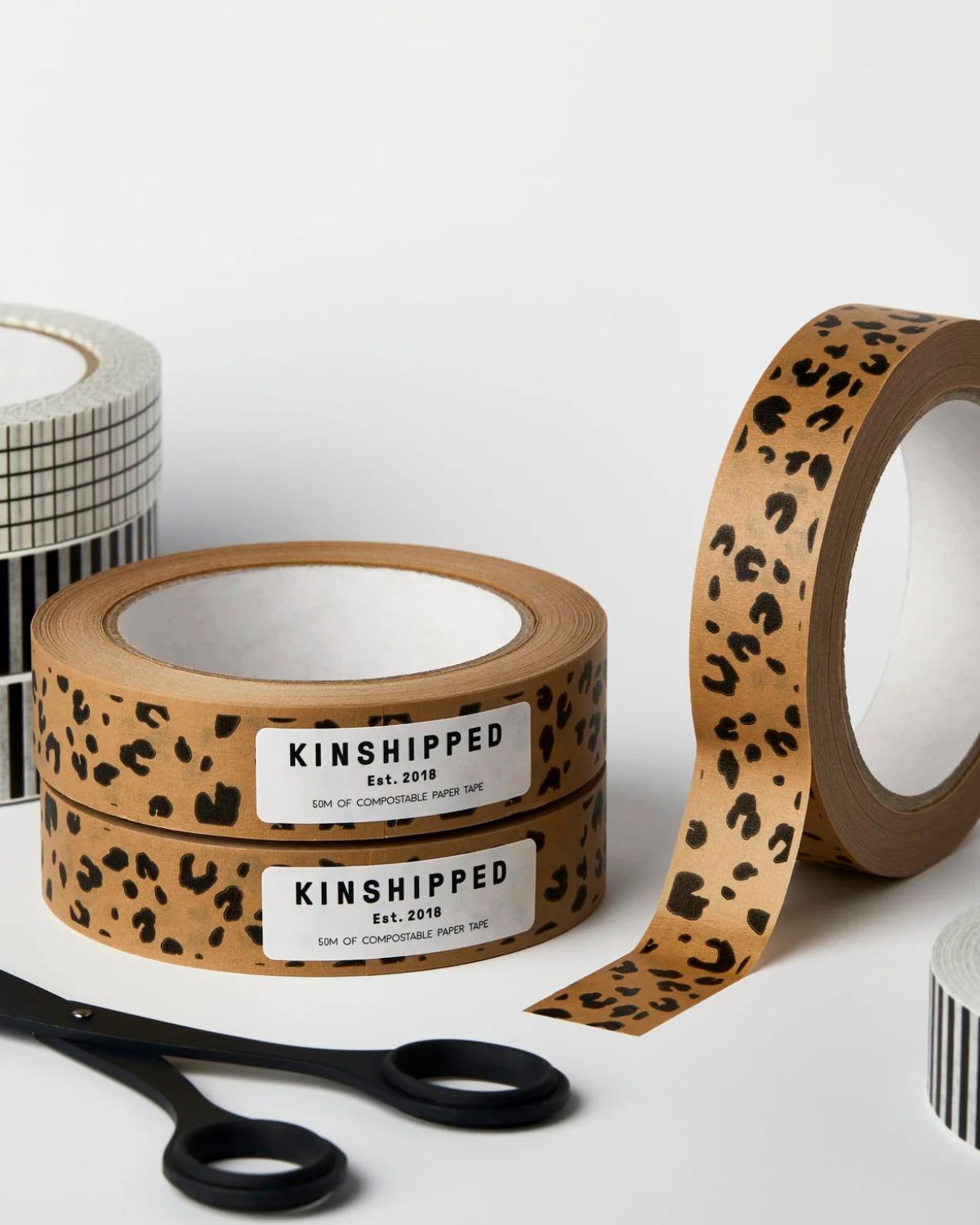 Two rolls of leopard print tape with 'KINSHIPPED' label on a white background