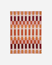 Checkered blanket with red and orange pattern on a white background