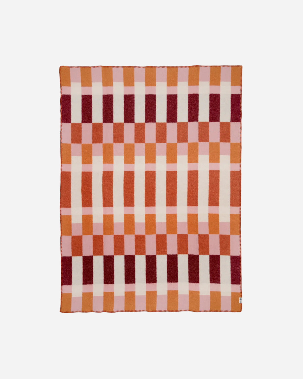 Checkered blanket with red and orange pattern on a white background