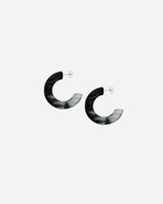 Pair of black and white hoop earrings on a light gray background