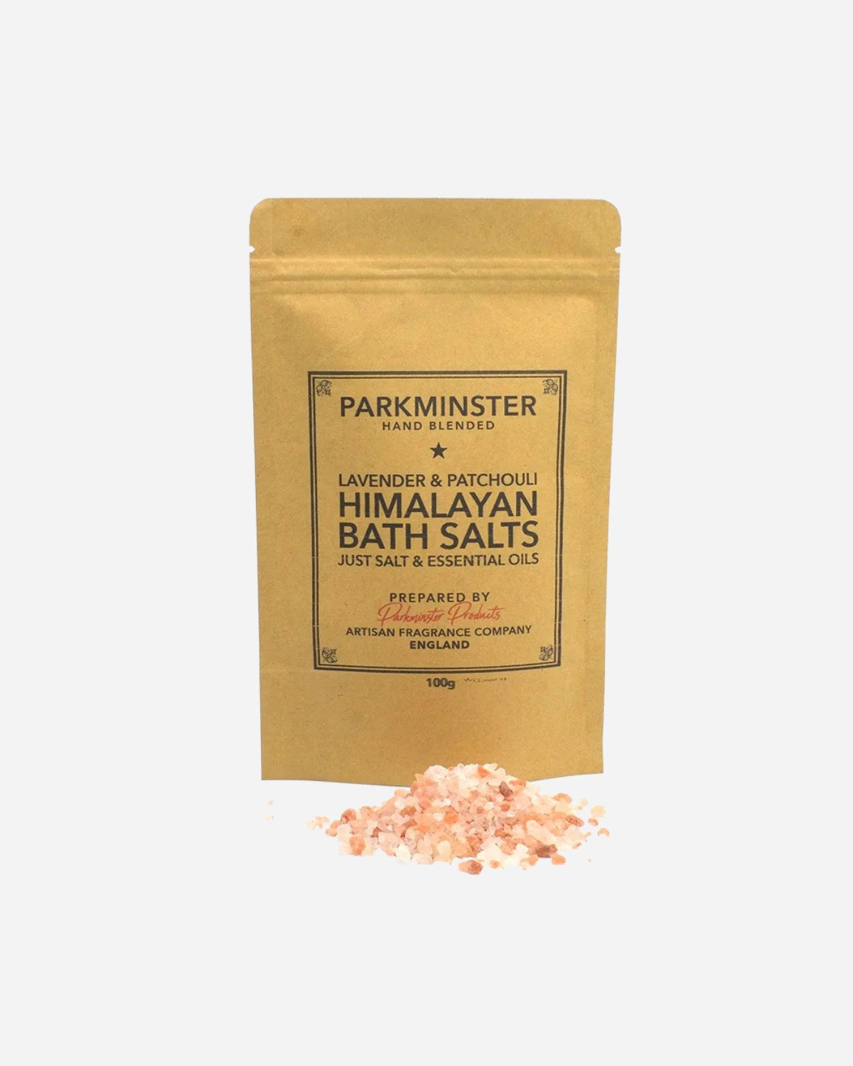 A pouch of Parkminster Lavender & Patchouli Himalayan Bath Salts with a small pile of pink Himalayan salts in front of it.