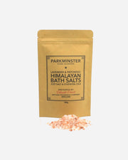 A pouch of Parkminster Lavender & Patchouli Himalayan Bath Salts with a small pile of pink Himalayan salts in front of it.