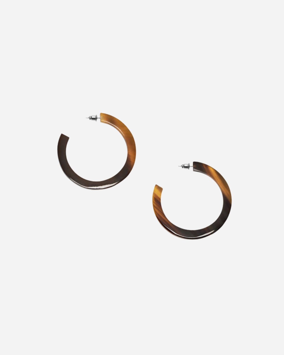 Tortoiseshell hoop earrings on a white background