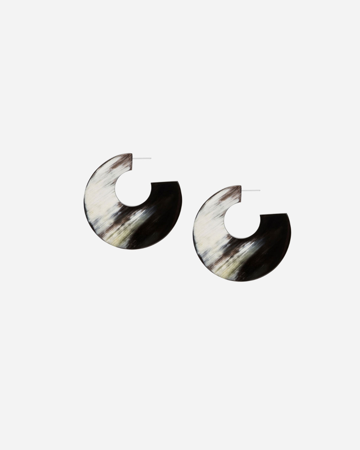 Pair of black and white horn earrings on a white background