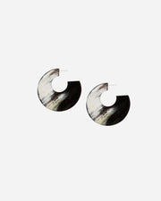 Pair of black and white horn earrings on a white background