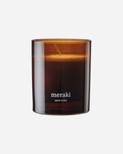 A boxed scented candle in a glass brown jar 