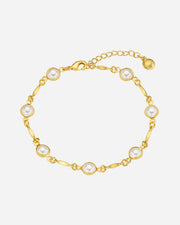 Gold bracelet with pearls on a white background