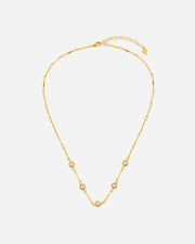Gold necklace with small pearls on a white background