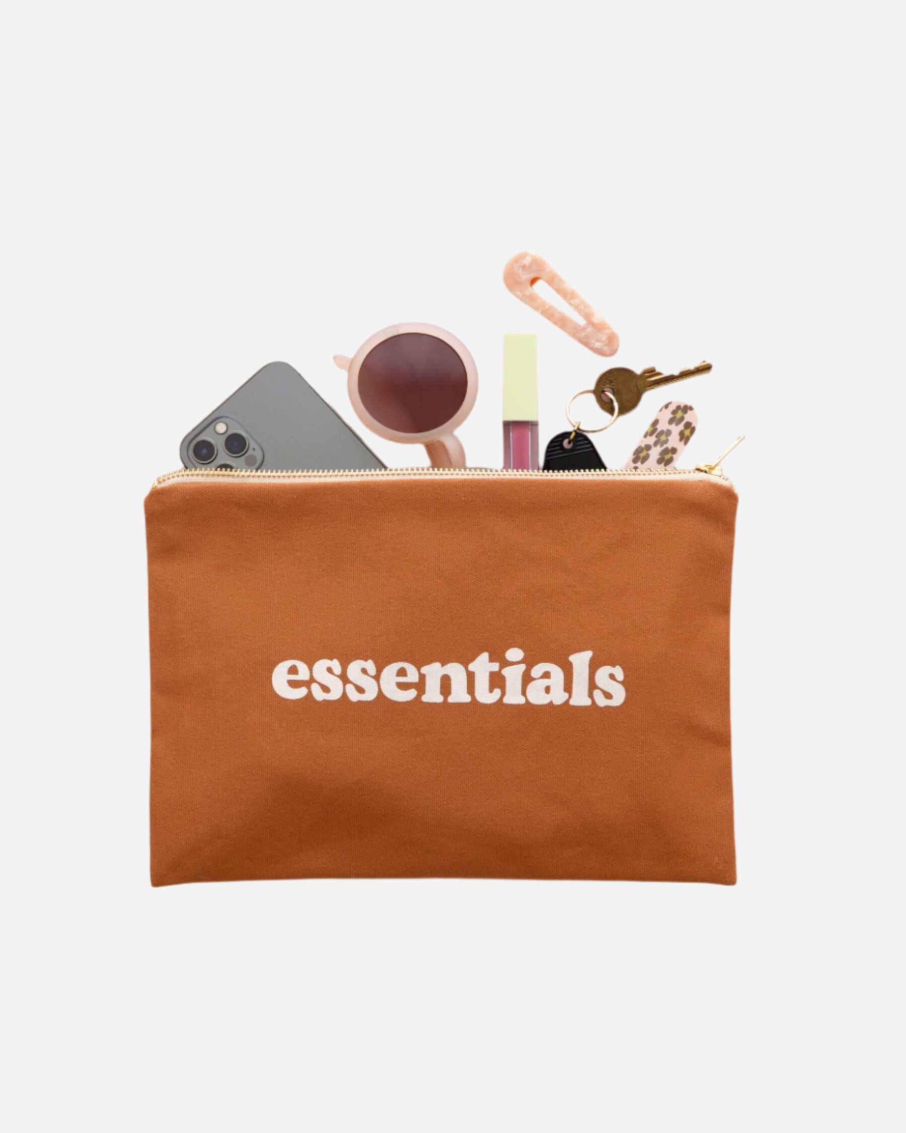 Tan canvas pouch with gold zip and ESSENTIALS printed in white