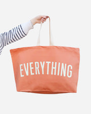 Peach canvas tote with white handles and EVERYTHING printed in white