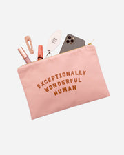 Pink canvas pouch with gold zip and EXCEPTIONALLY WONDERFUL HUMAN slogan in tan