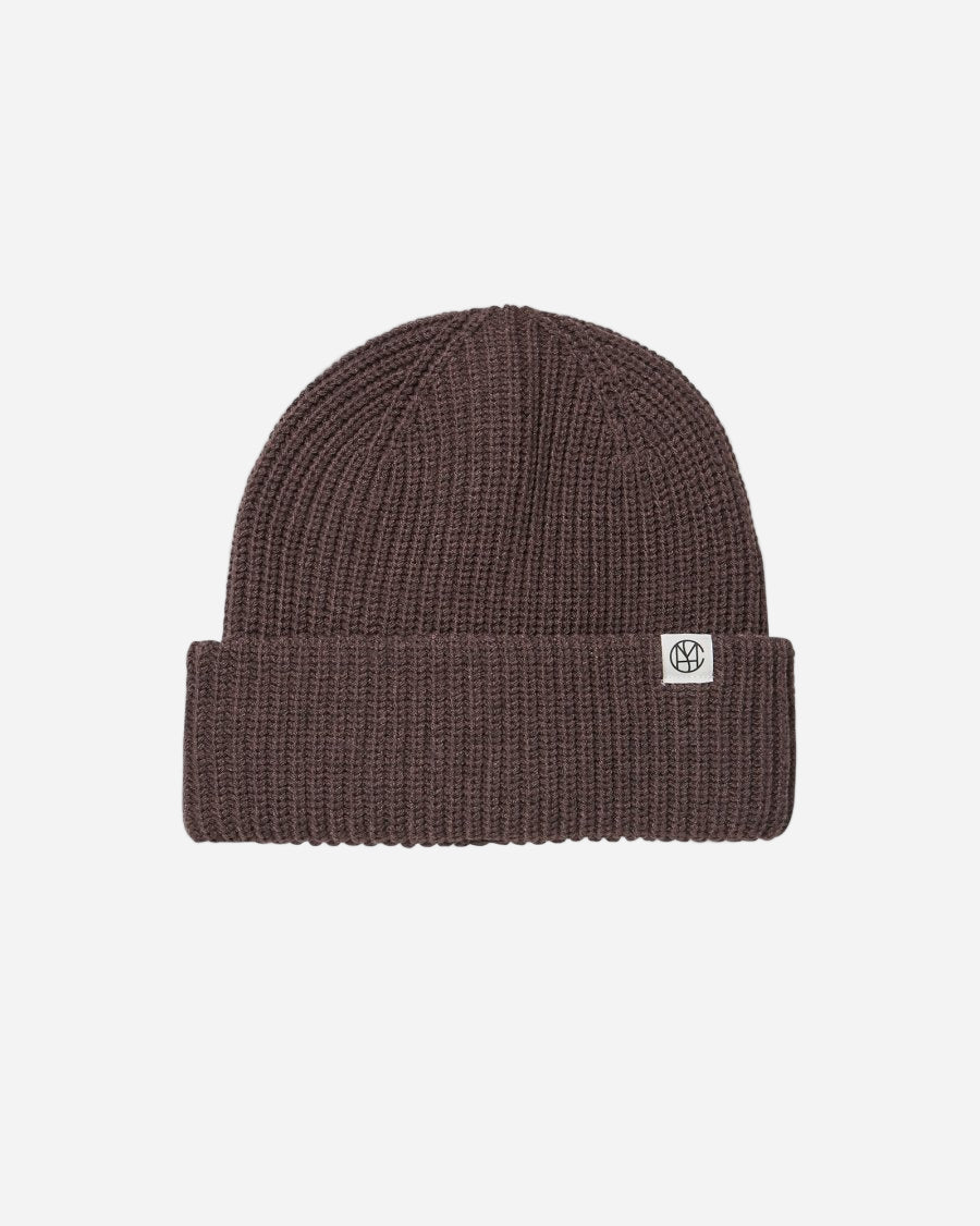 Brown beanie with a logo on a light gray background