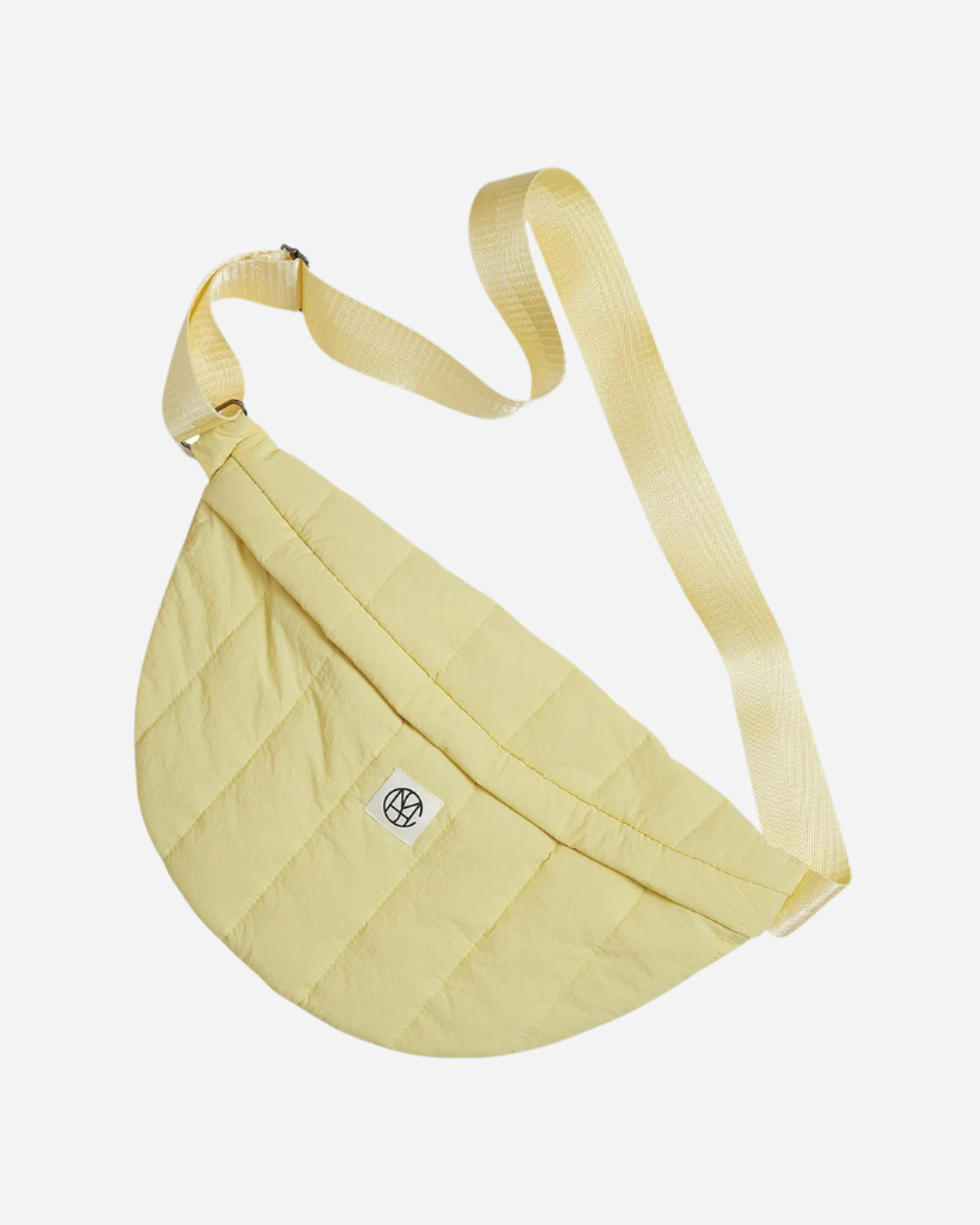 Yellow quilted bag with a strap on a white background