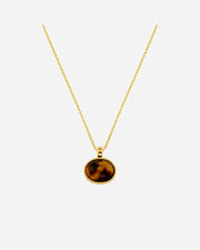 Gold necklace with a tiger's eye pendant on a white background