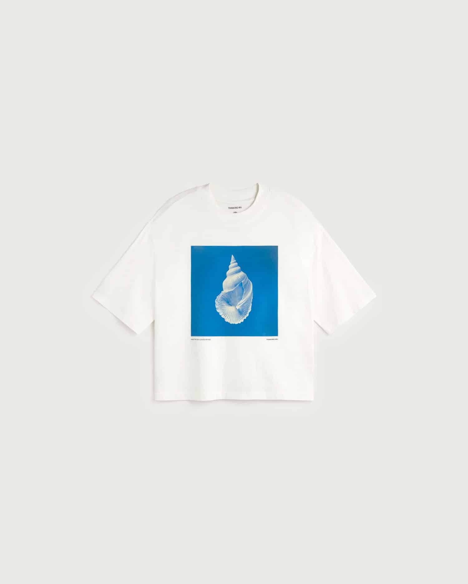 White t-shirt with a blue square graphic featuring a white shell design on a white background