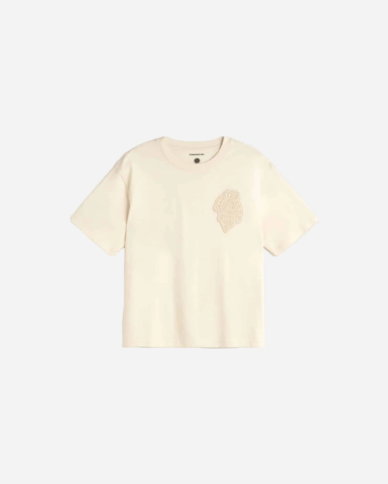 Beige t-shirt with a small graphic on a light gray background